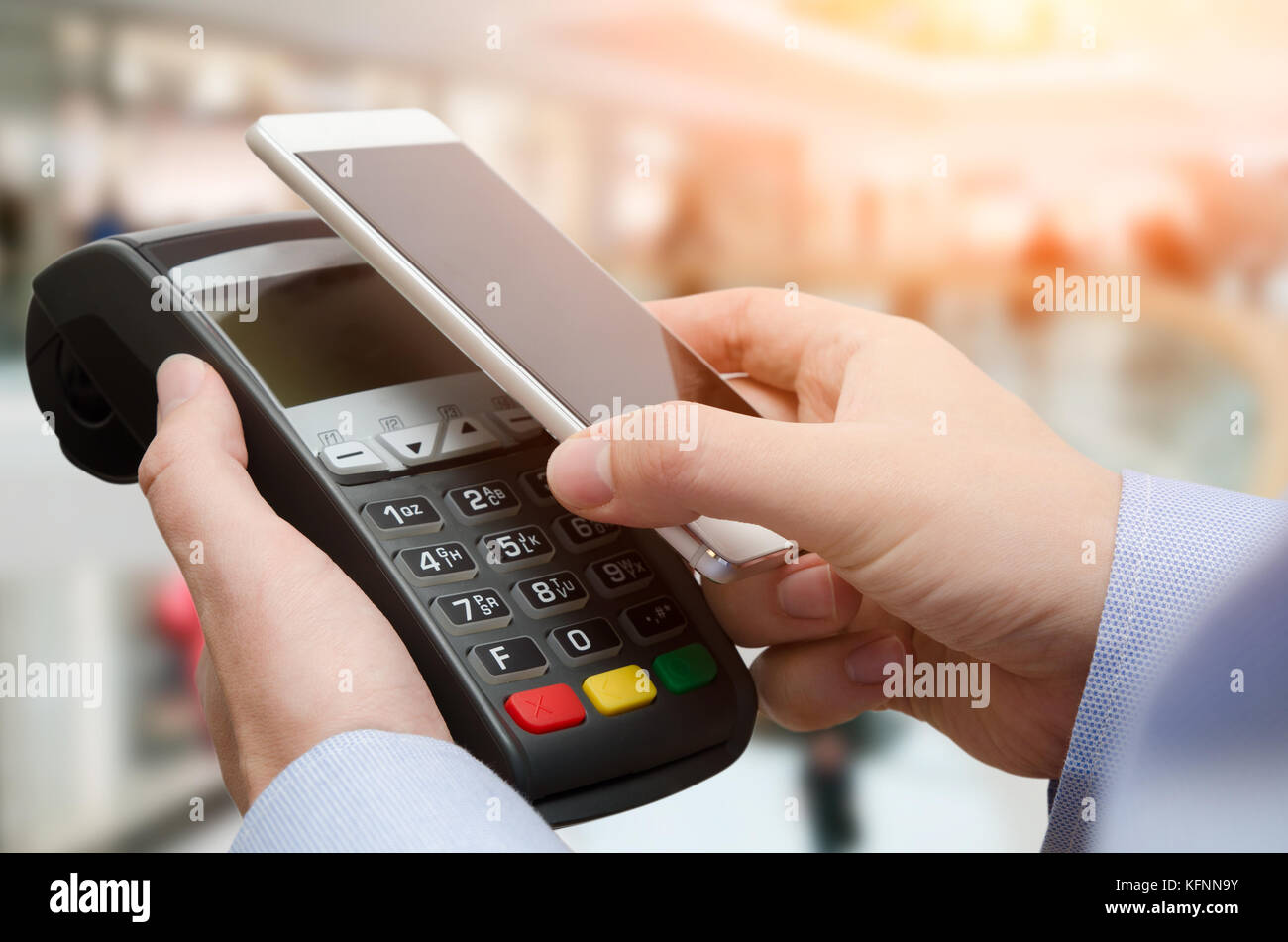 Man using credit card payment machine. Mobile payment with contactless smart phone application Stock Photo