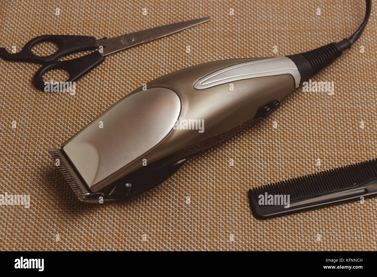 Stylish Professional Hair Clippers, accessories on brown background