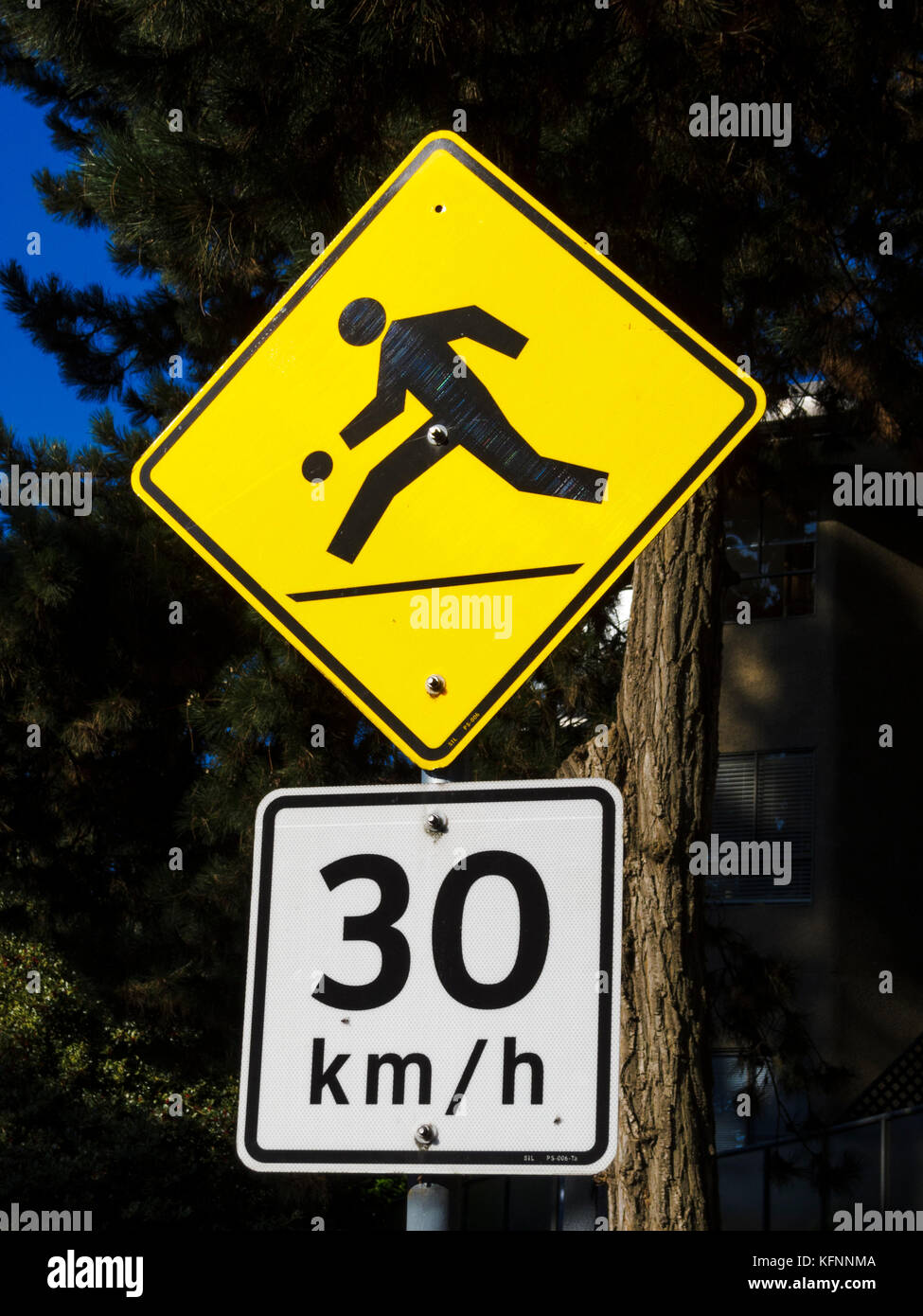 Signs warning of kids playing and 30 km/h speed limit Stock Photo - Alamy