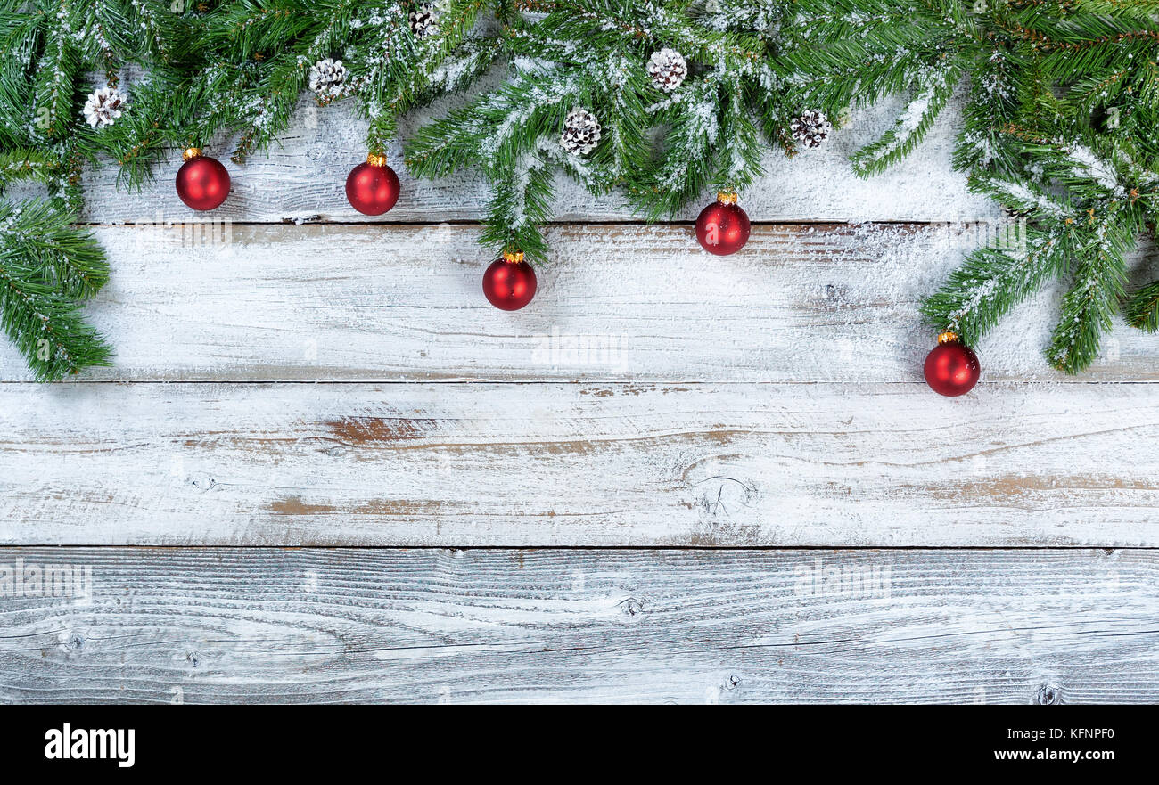 Snowy Christmas fir branches with traditional red ball ornaments and ...