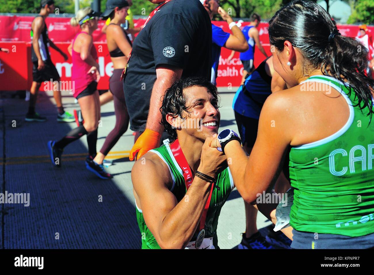 Just after crossing the finish line at the 2017 Chicago Marathon, a runner got down to one knee and proposed to a fellow competitor. Stock Photo