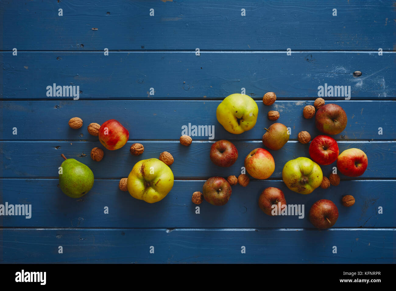 autumnal fruits on blue wooden table Stock Photo