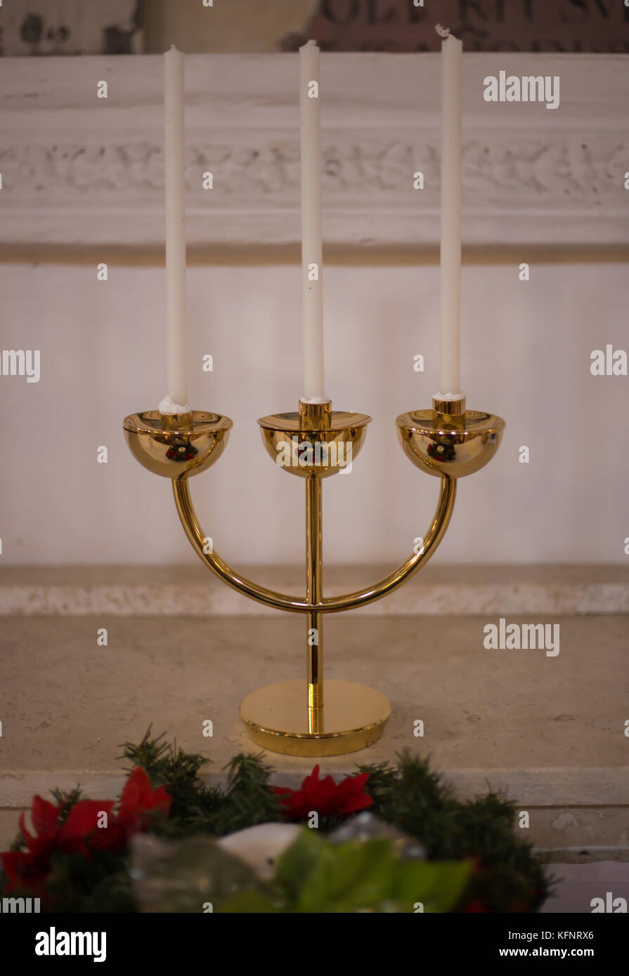 Golden candlestick with three candles in church Stock Photo Alamy