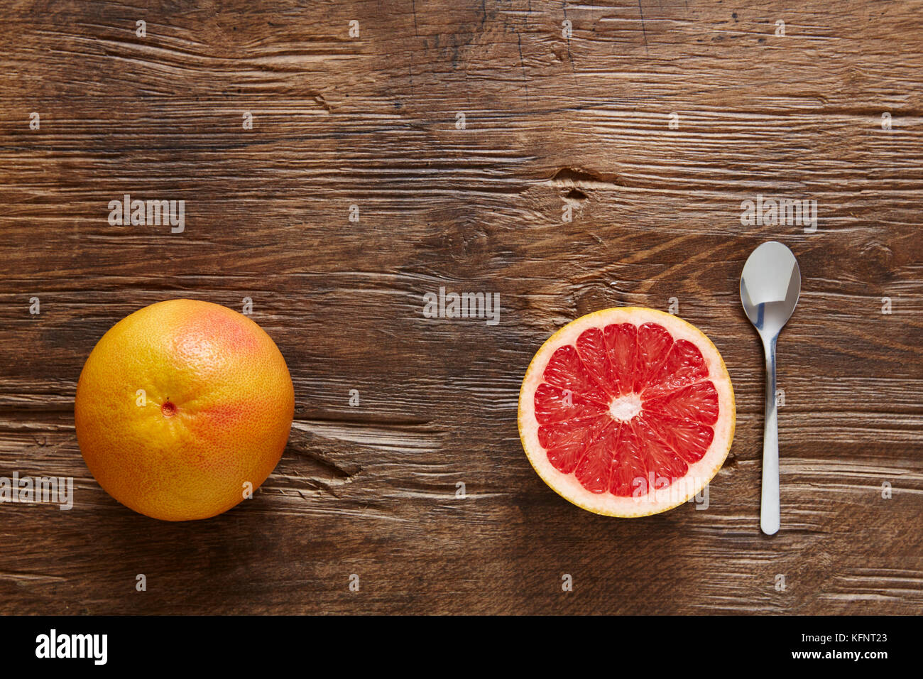 whole and sliced organic grapefruit with spoon ready to eat Stock Photo Alamy