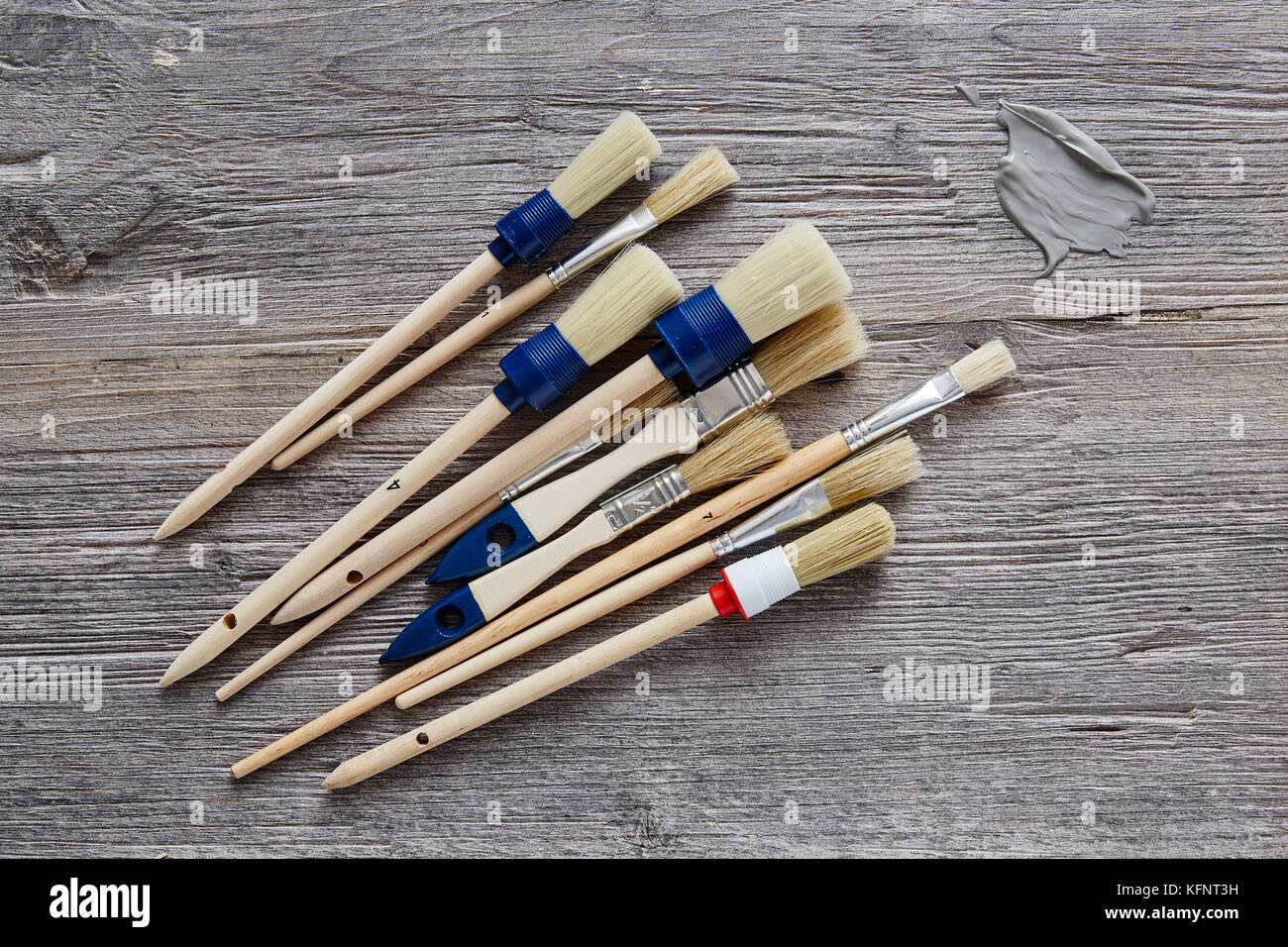 unorganised paintbrushes with blob of paint Stock Photo