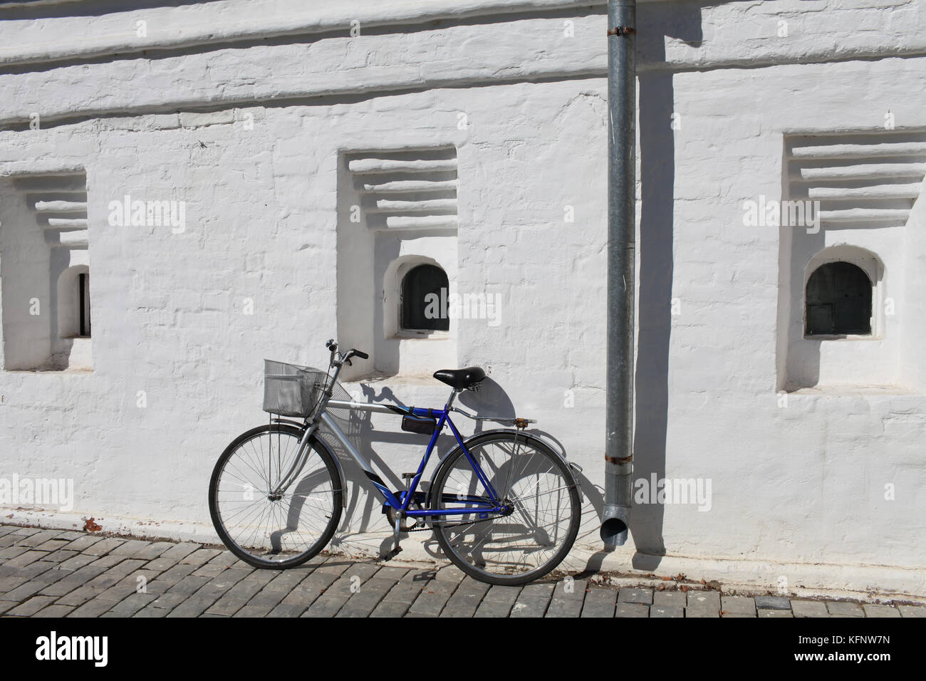 road Bicycle leaning against a white wall Stock Photo