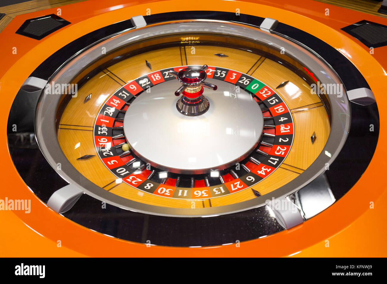 Roulette table in casino. Ball in the rotating gambling machine. Wooden