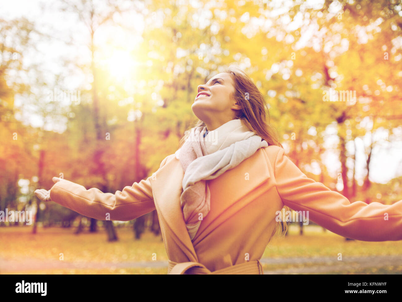 beautiful happy young woman walking in autumn park Stock Photo - Alamy