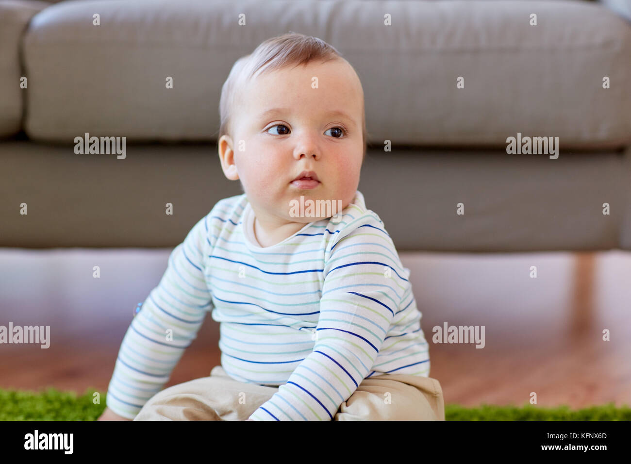 baby boy sitting on floor at home Stock Photo - Alamy