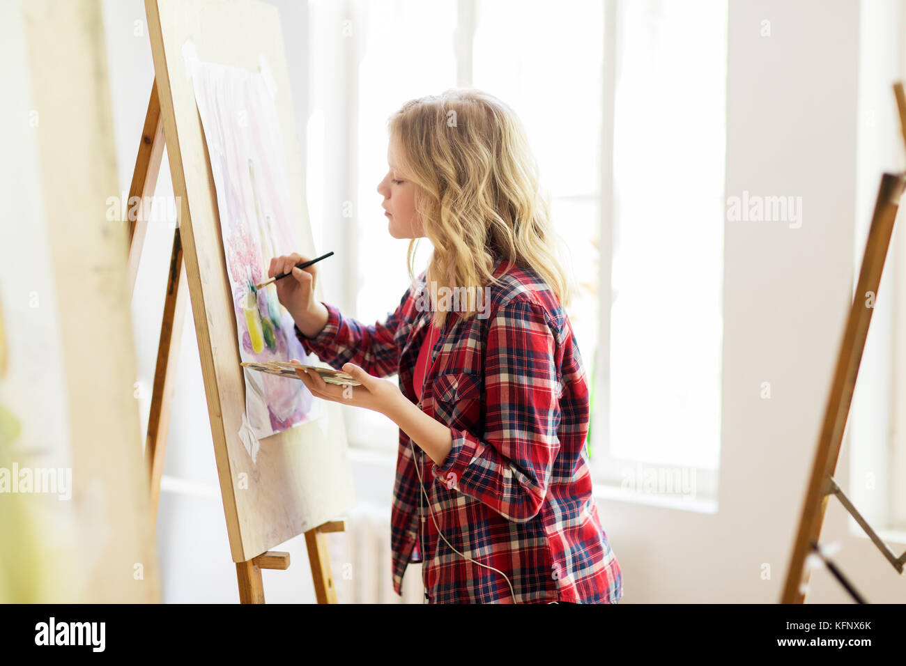 student girl with easel painting at art school Stock Photo - Alamy