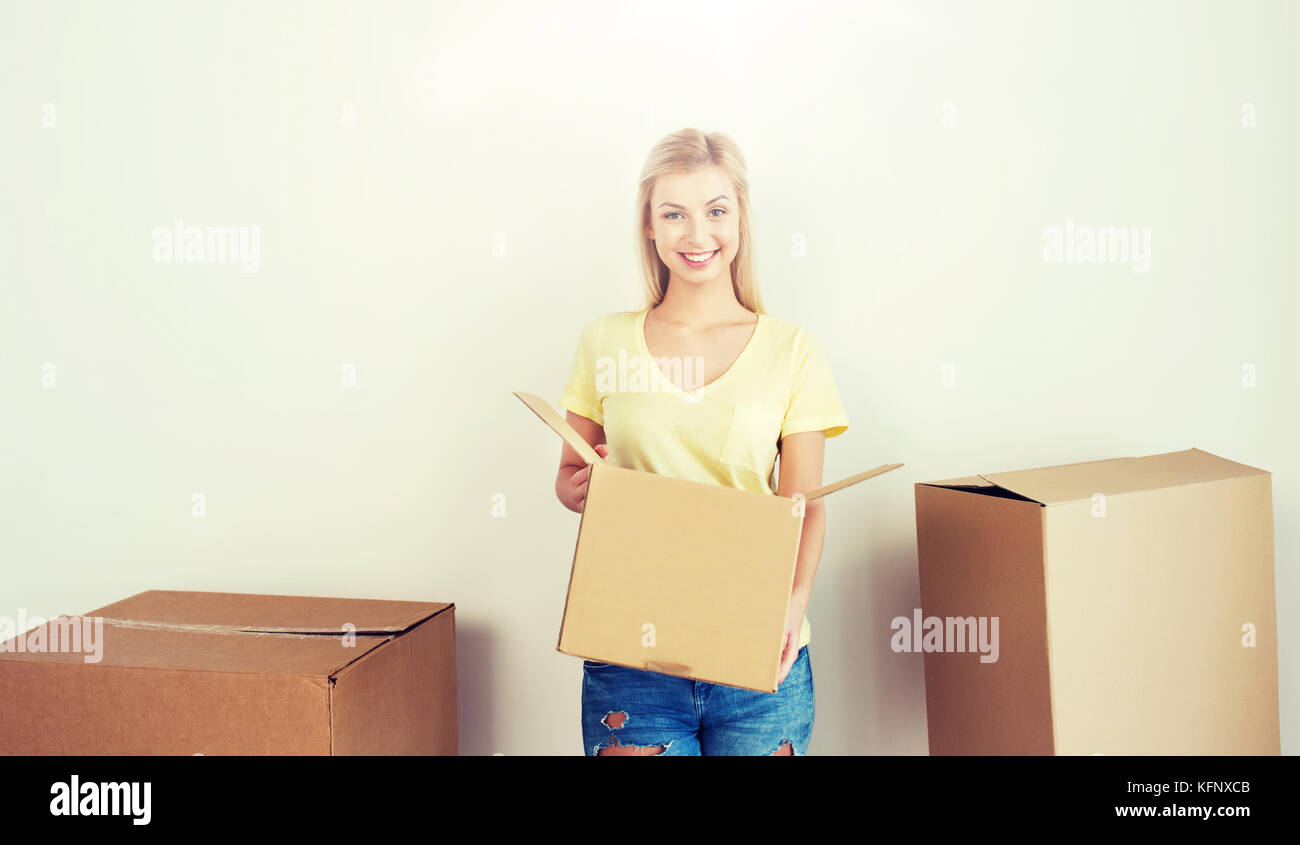 smiling young woman with cardboard box at home Stock Photo - Alamy