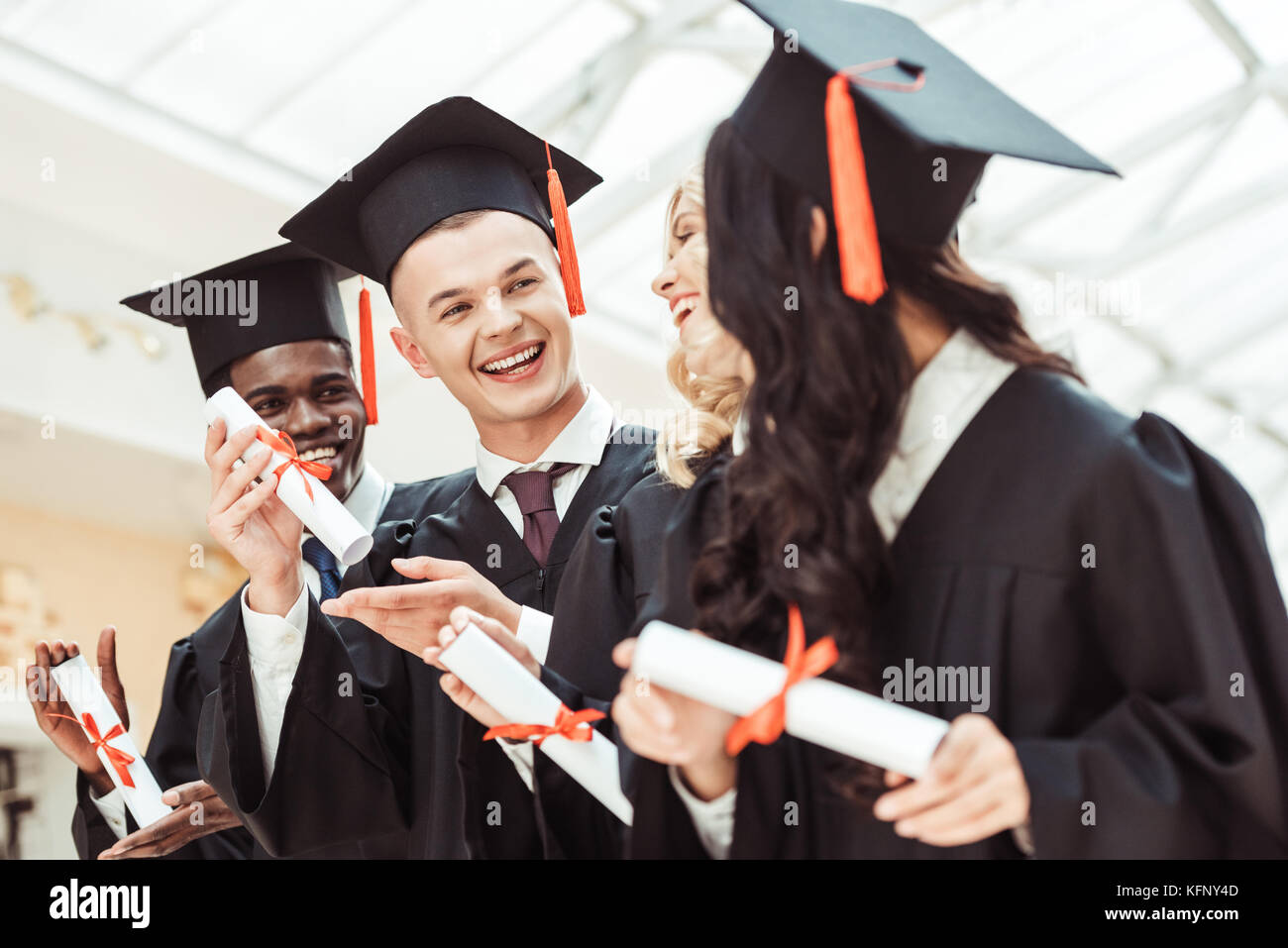 multiethnic students with diplomas Stock Photo