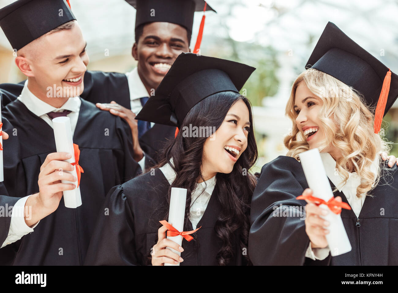 multiethnic students with diplomas Stock Photo