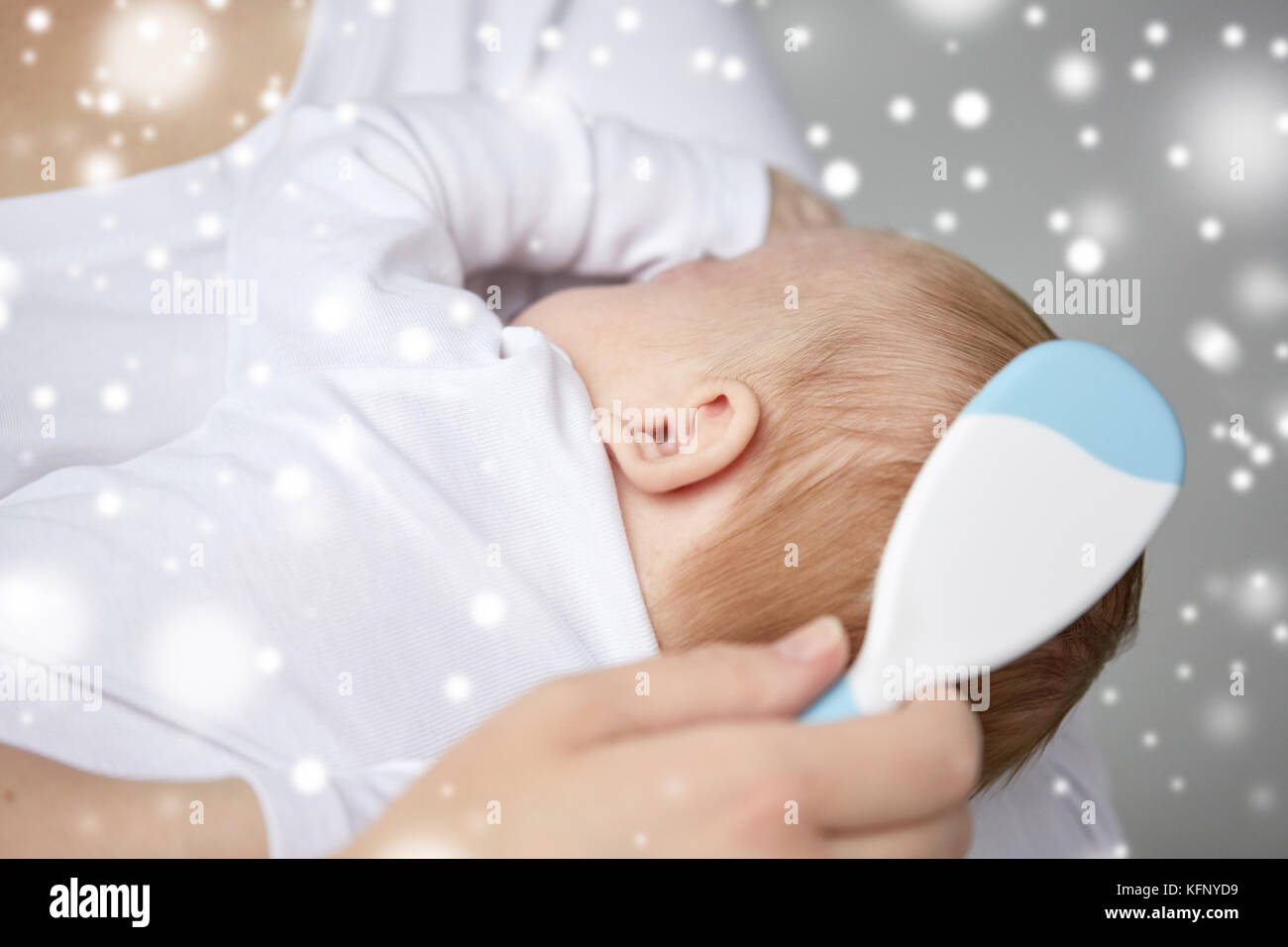 close up of mother brushing newborn baby hair Stock Photo Alamy