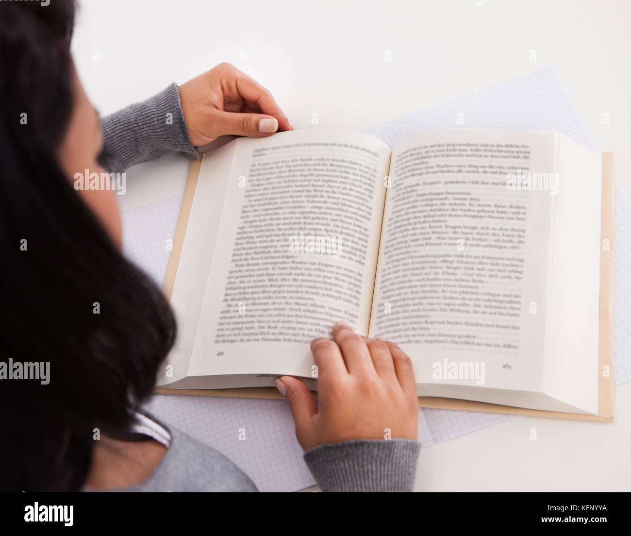 Young Happy Woman Reading Book At Home Stock Photo