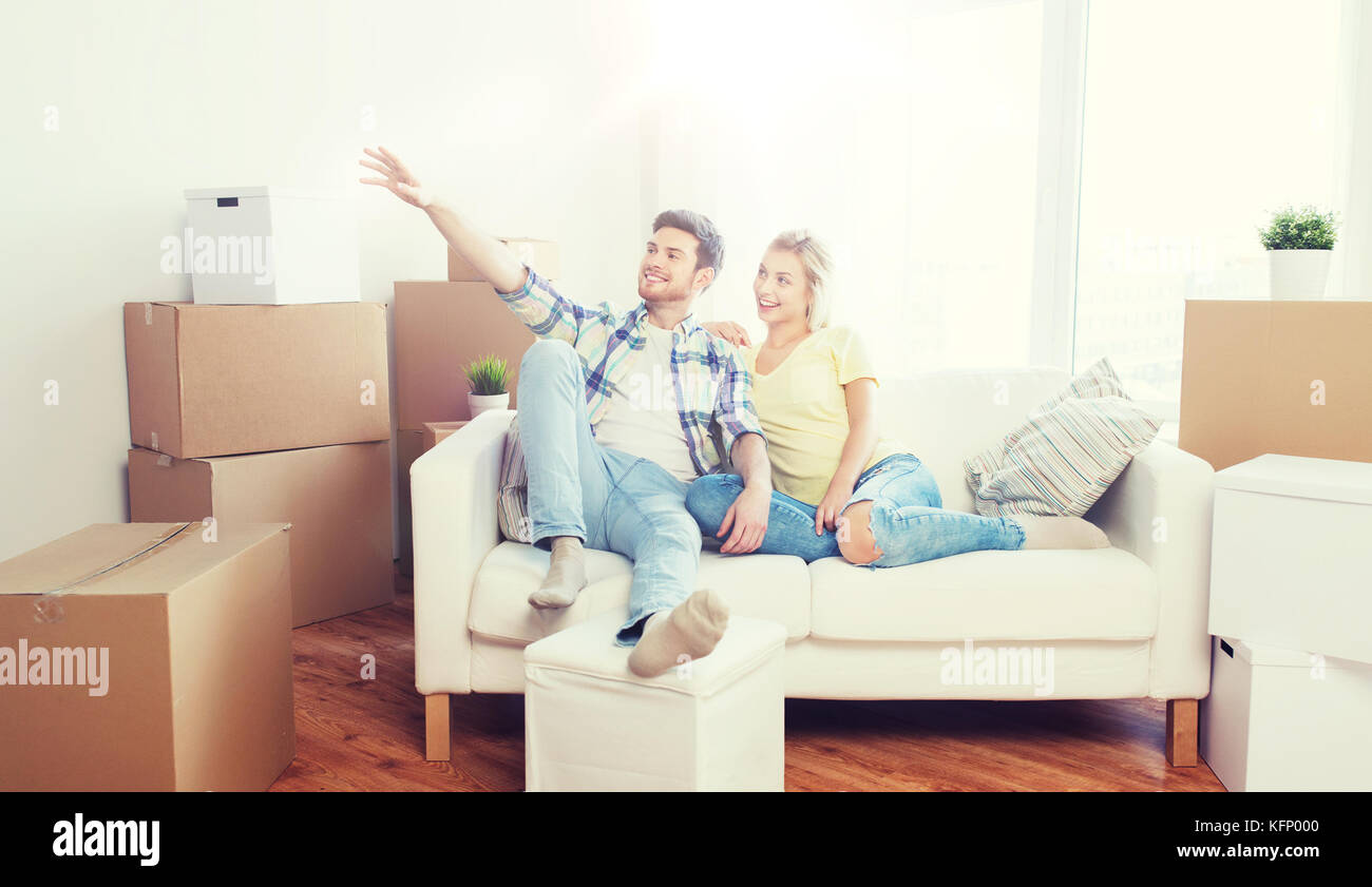 couple with boxes moving to new home and dreaming Stock Photo - Alamy
