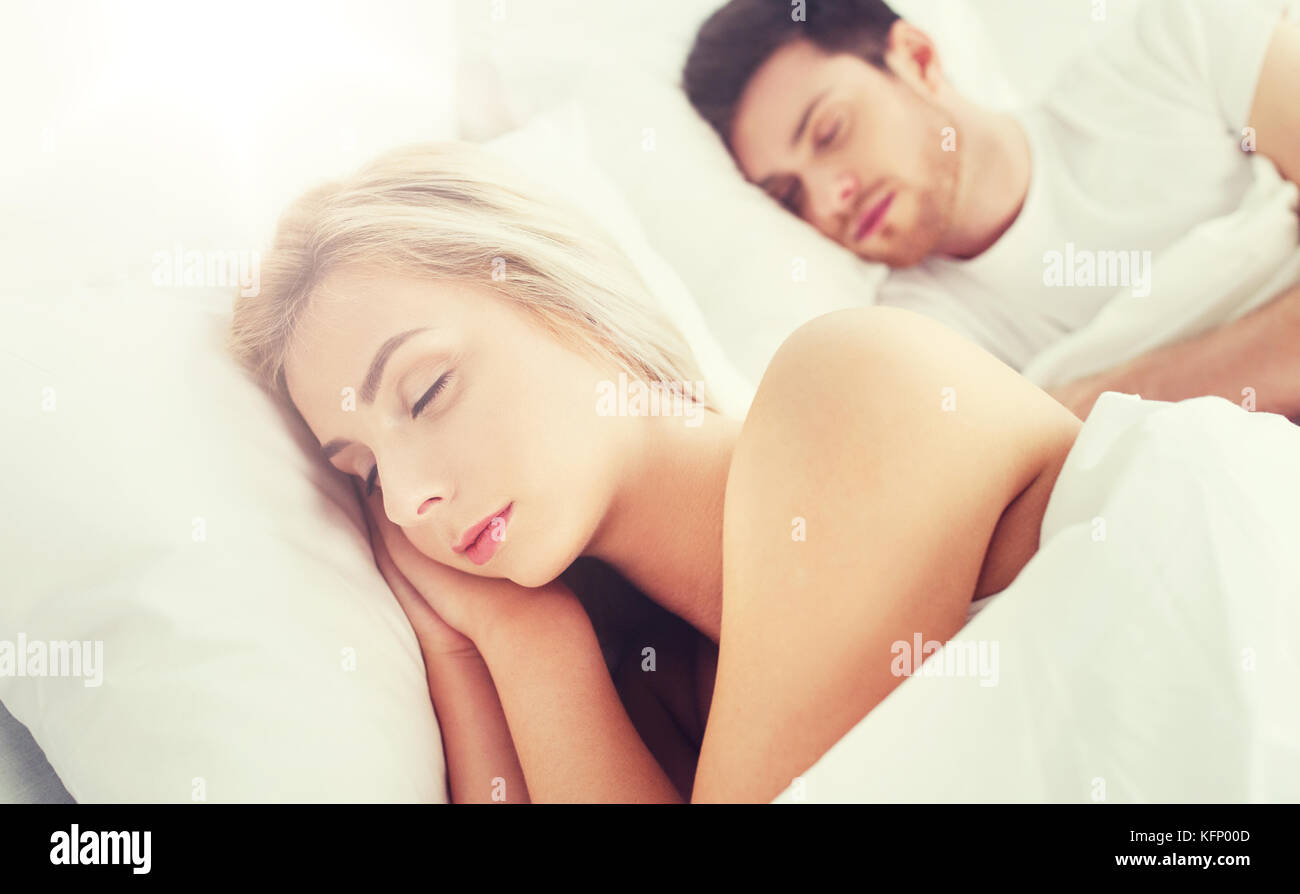 happy couple sleeping in bed at home Stock Photo - Alamy