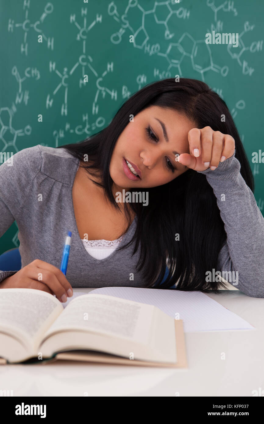 Portrait Of Young Female Student Studying In Classroom Stock Photo - Alamy
