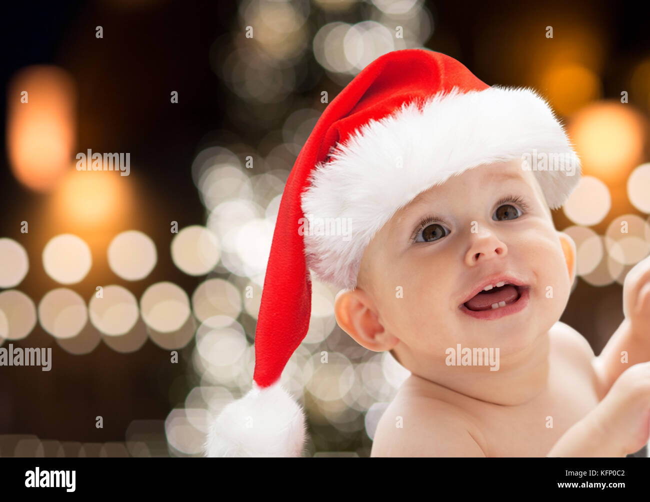 close up of little baby in santa hat at christmas Stock Photo