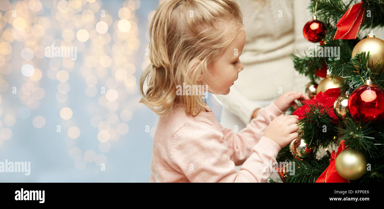 close up of little girl decorating christmas tree Stock Photo - Alamy