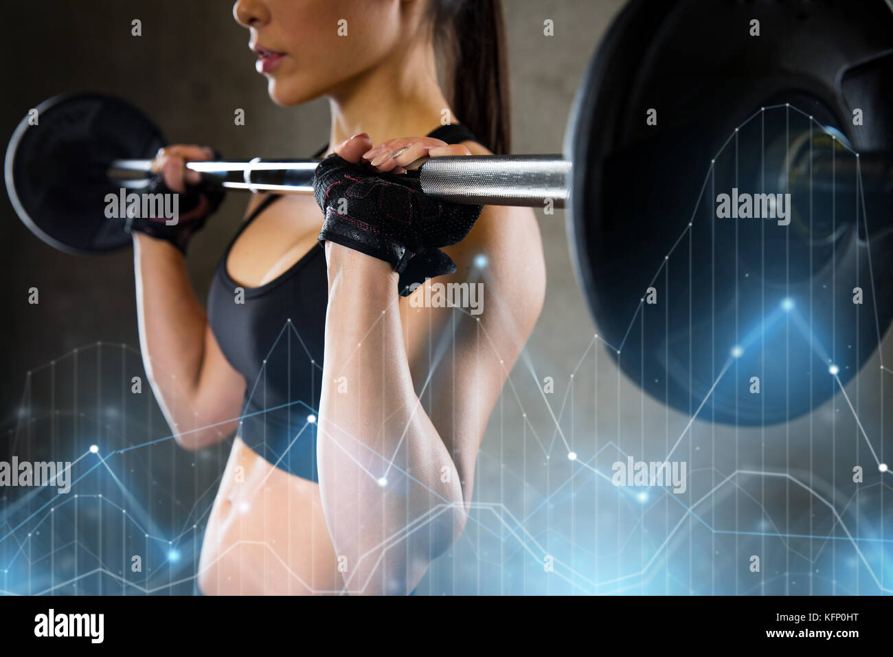 woman holding barbell in gym Stock