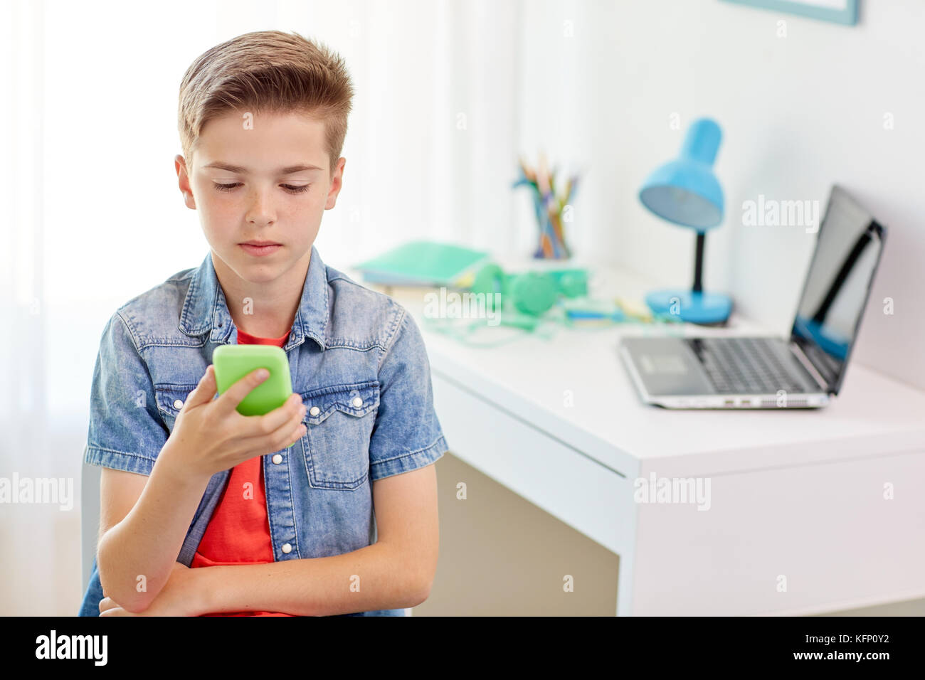 boy with smartphone being bullied by text message Stock Photo - Alamy