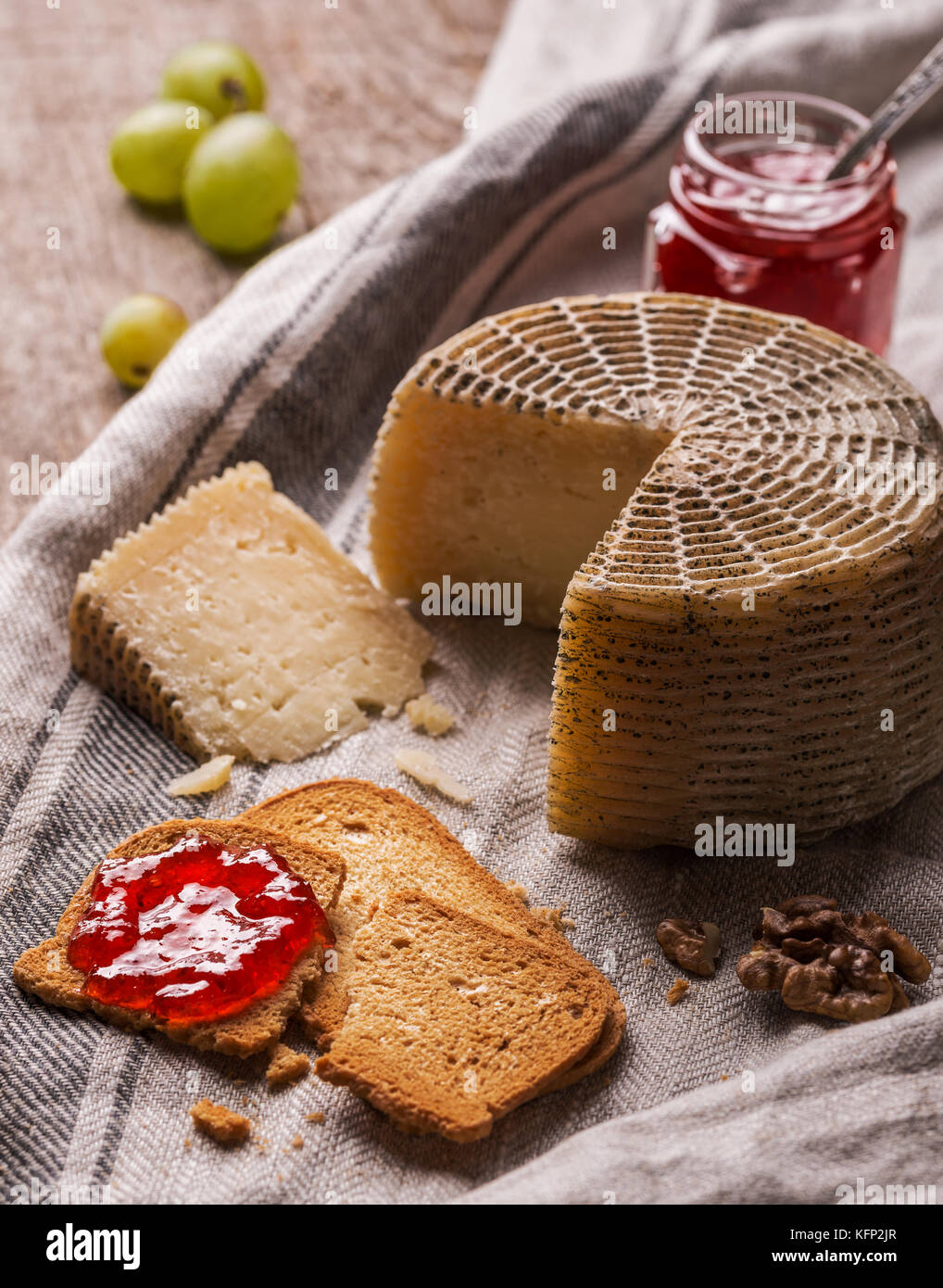 Still life with goat cheese, bread slices and jam Stock Photo