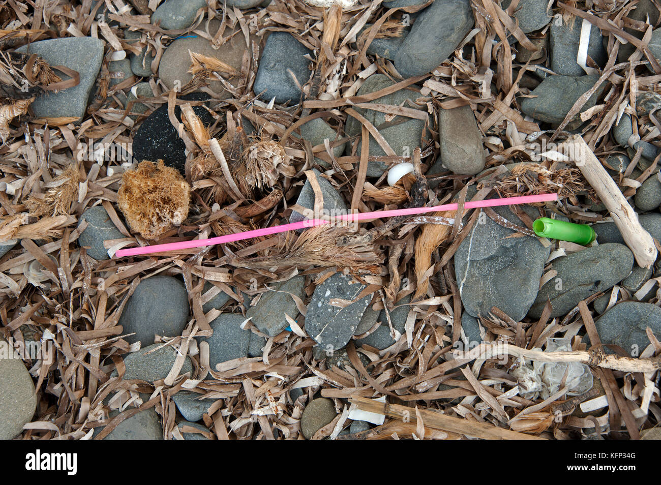 Washed up plastic straw litter a beach on the island of Menorca in the