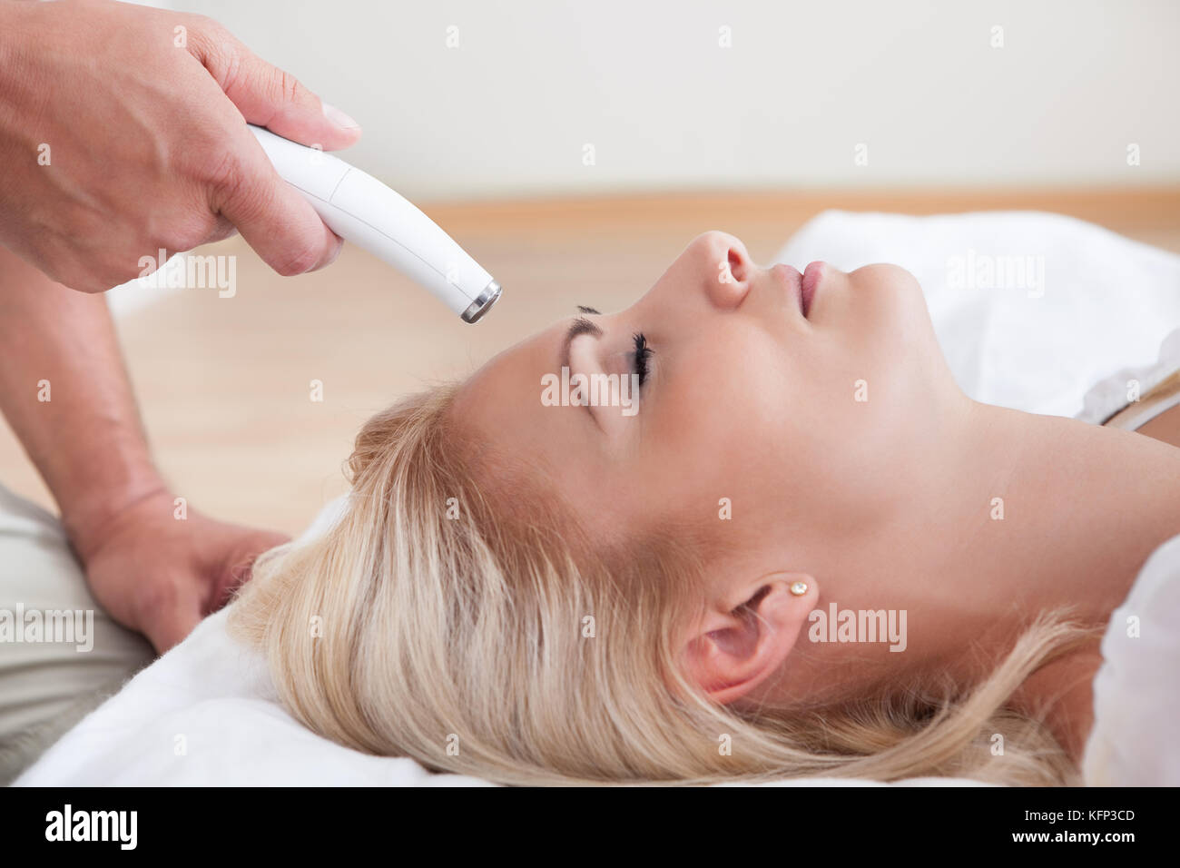 Profile View Of Happy Young Woman During Cosmetic Treatment, Indoors Stock Photo