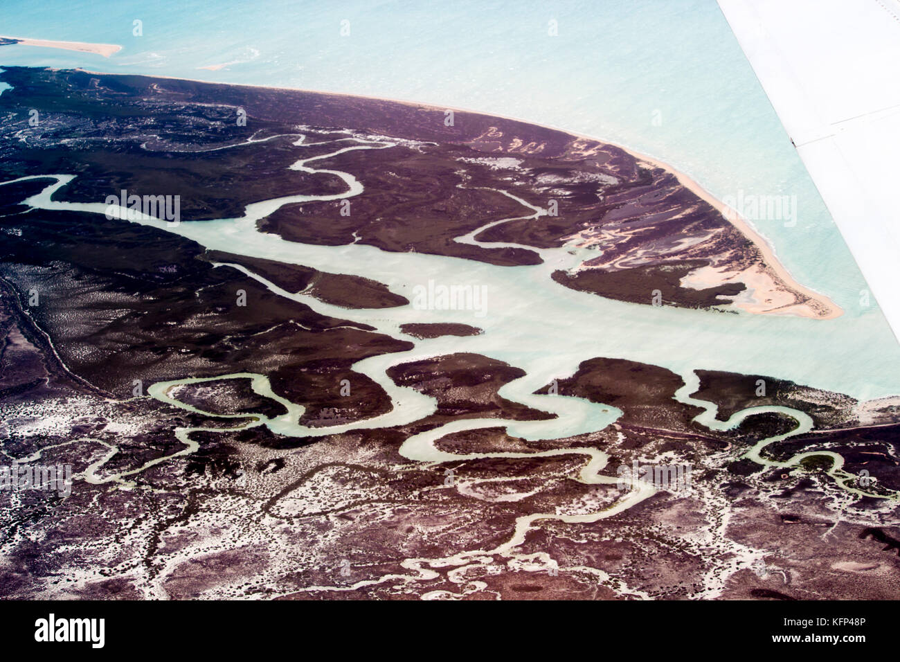 Aerial view of the tidal flat inlets south of Broome, North Western Australia as the plane descends for landing on a hot afternoon in the Summer Wet. Stock Photo