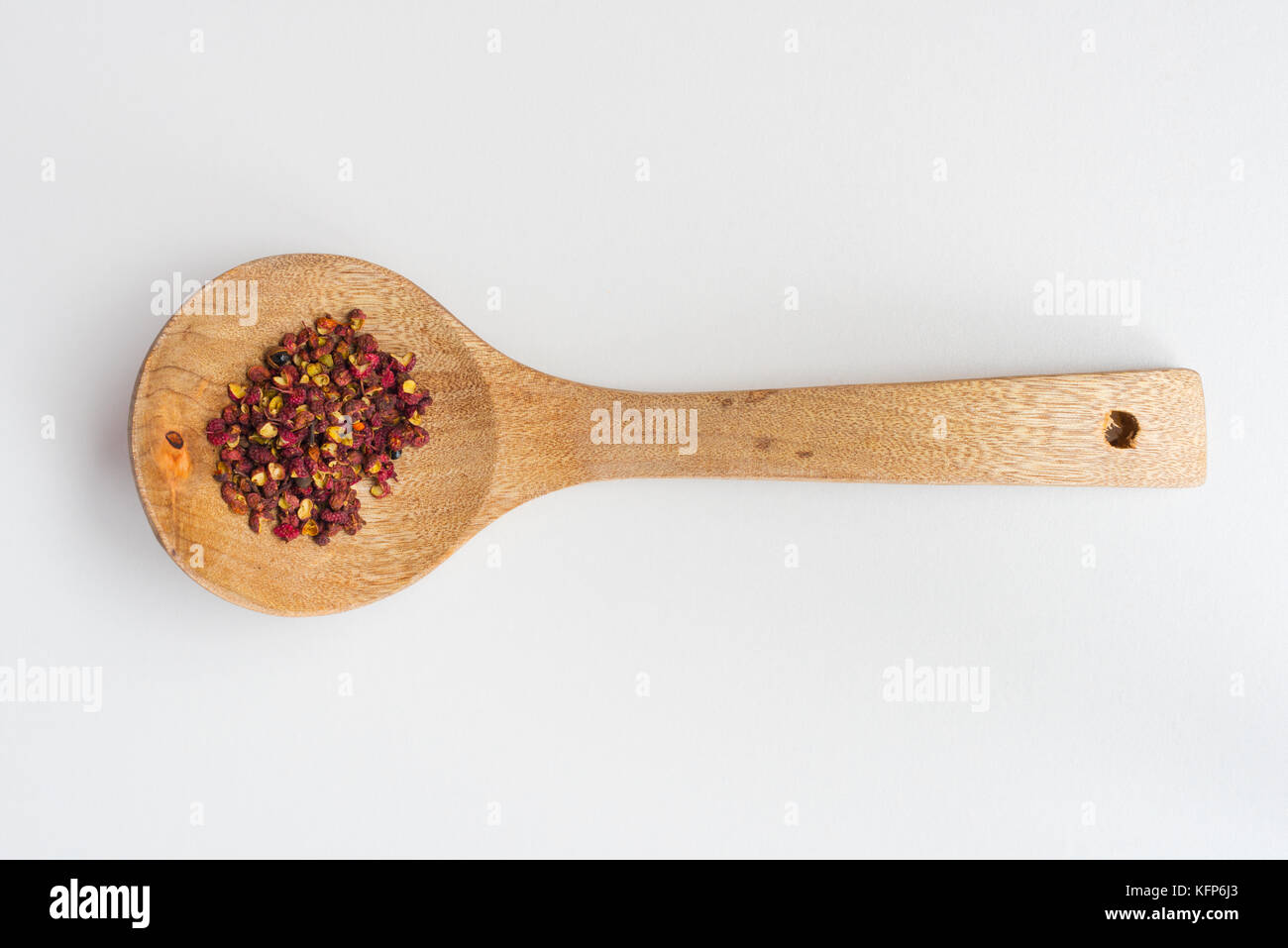 Sichuan red peppercorn in a wood spoon Stock Photo