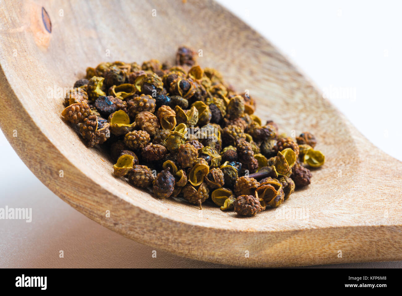 Sichuan green peppercorn close-up in a wood spoon Stock Photo