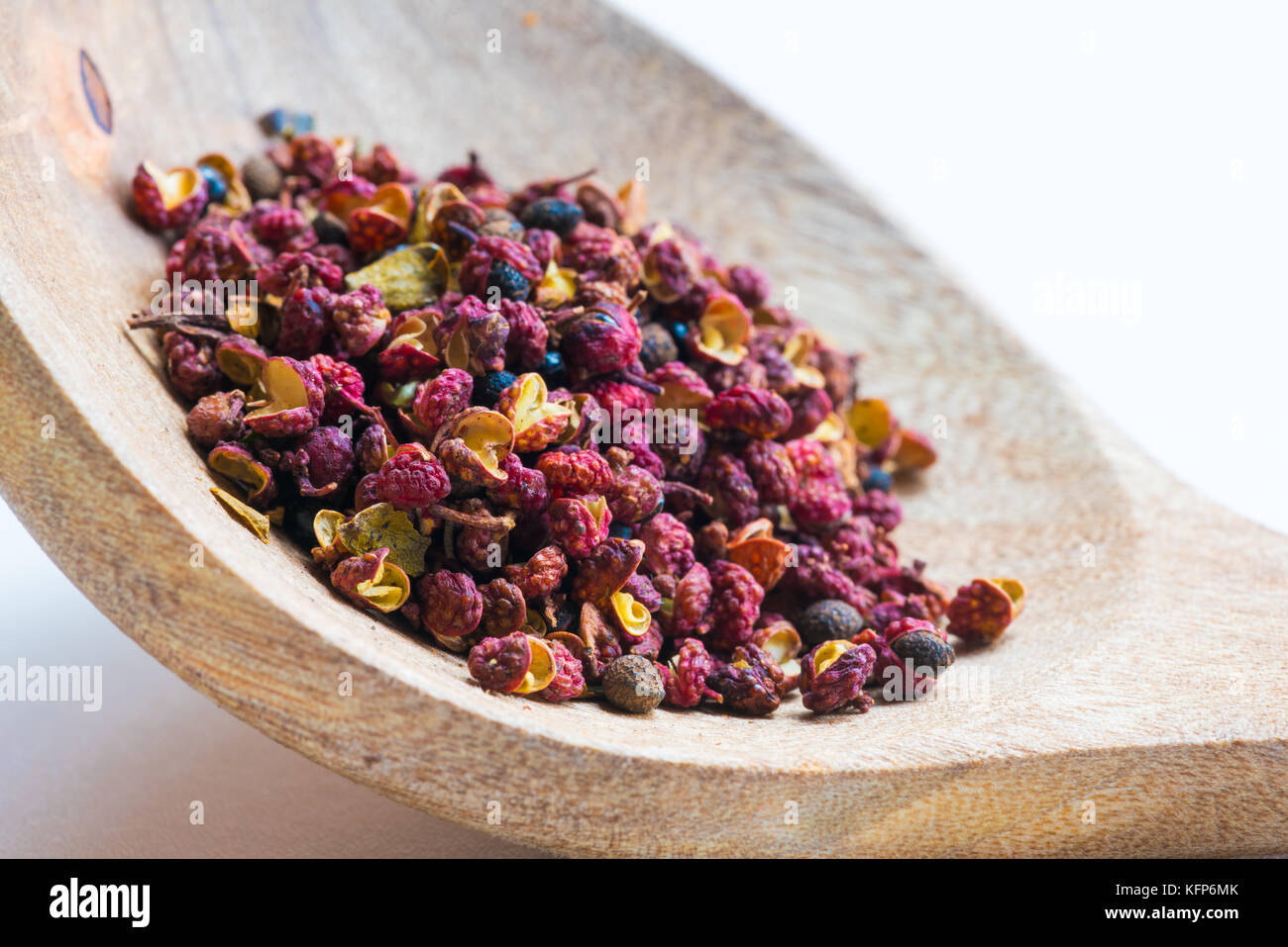 Sichuan red peppercorn closeup in a wood spoon Stock Photo