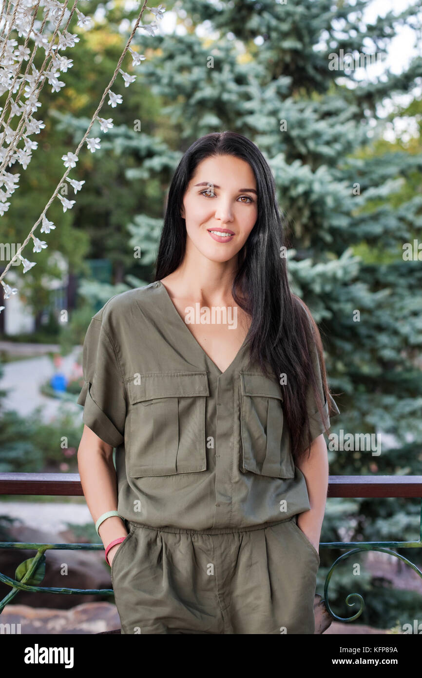 woman standing agains green nature of park Stock Photo - Alamy