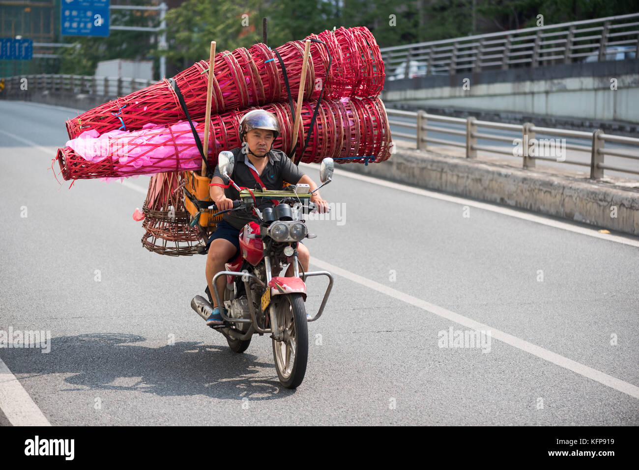 Chinese man on motorbike  Stock Photo