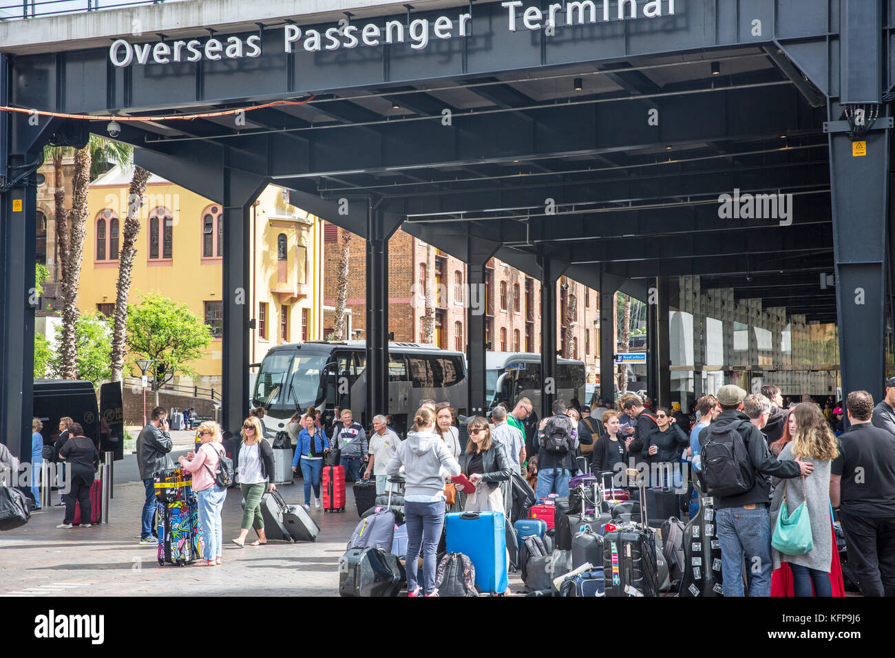 Passengers with luggage after disembarking a cruise ship at the Overseas Passenger Terminal in
