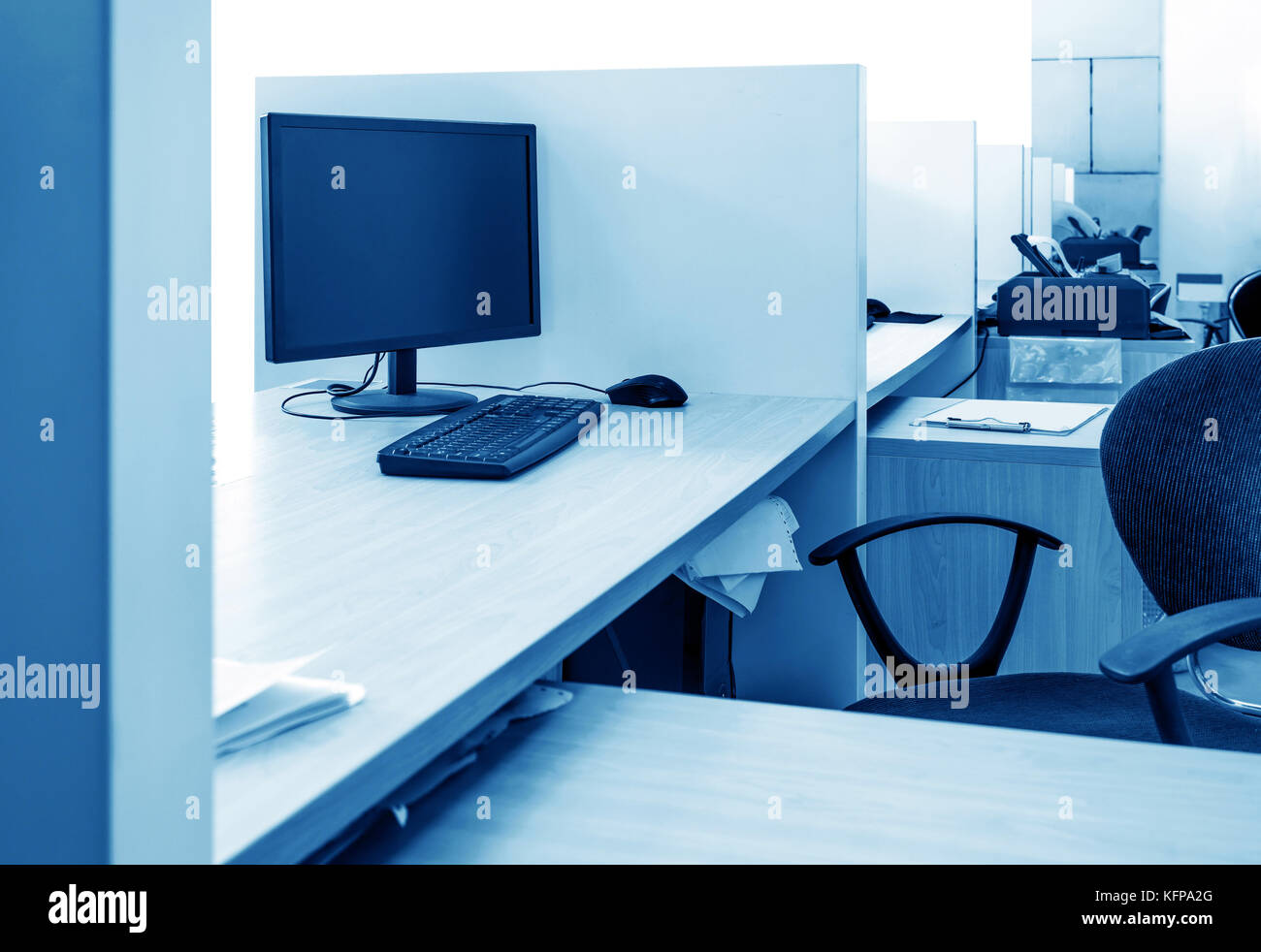 Office tables and chairs and computers blue tones stock photo alamy