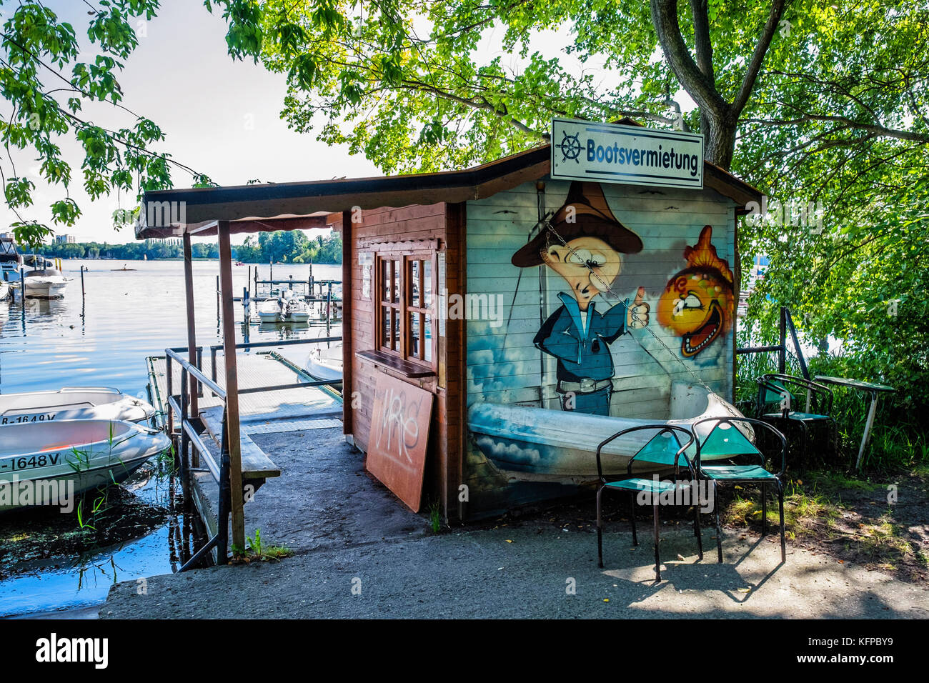 Berlin Tegel. Boat hire shed with artwork of sailor and fish. Moored