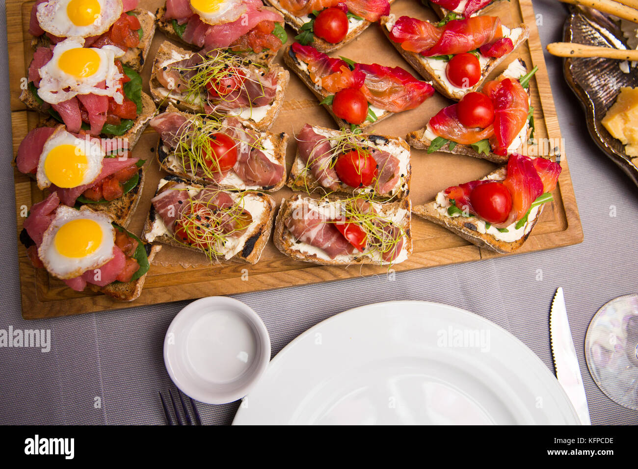 Selection of tasty bruschetta or canapes on taosted baguette and quark