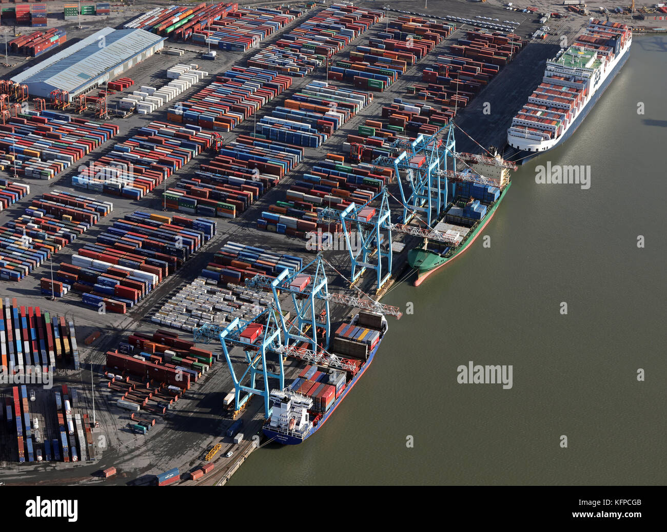 aerial view of 3 ships at Seaforth Docks, a container terminal, on the River Mersey, UK Stock Photo