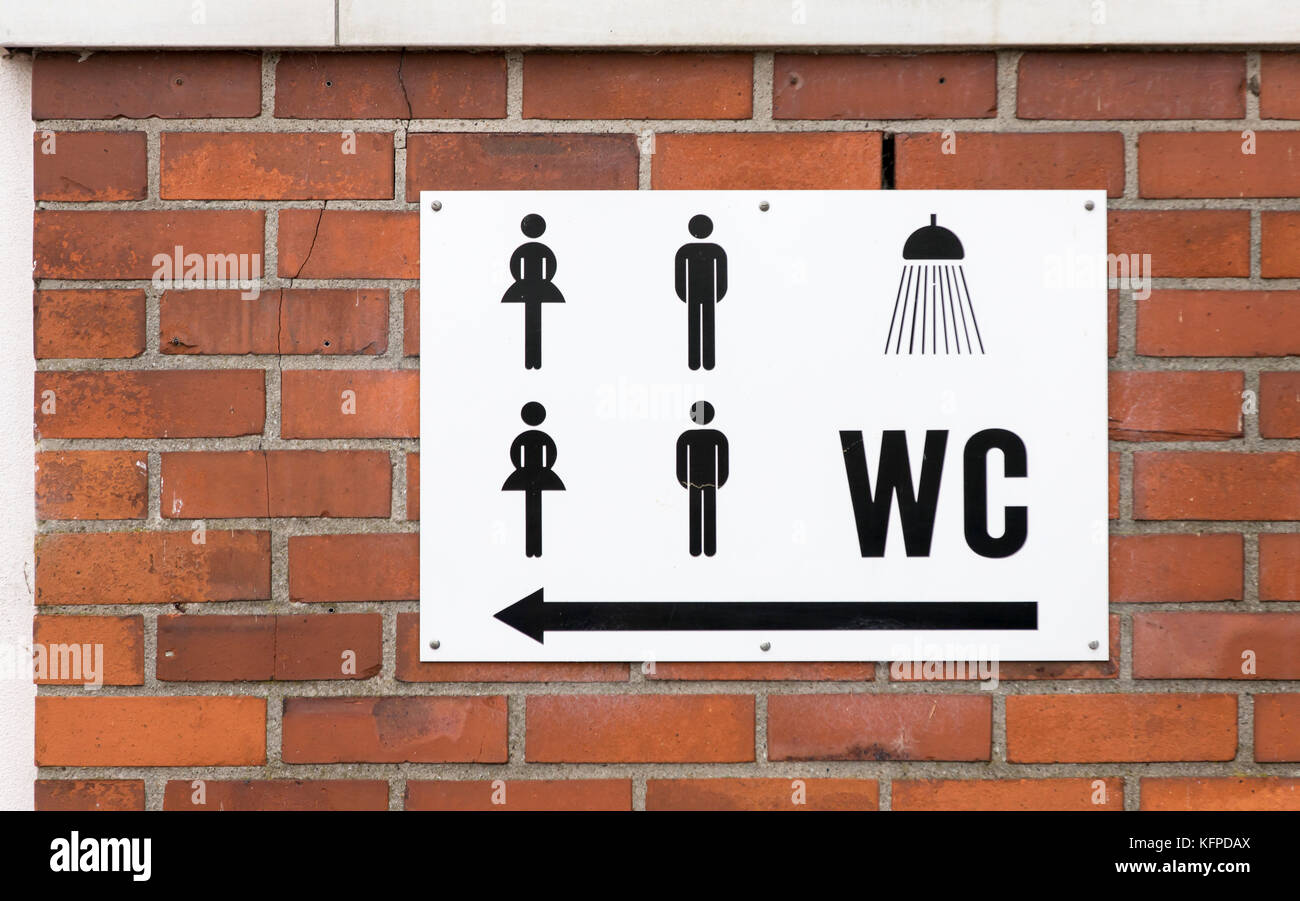 Public swimming pool, sign shows way to showers and toilets, Stock Photo