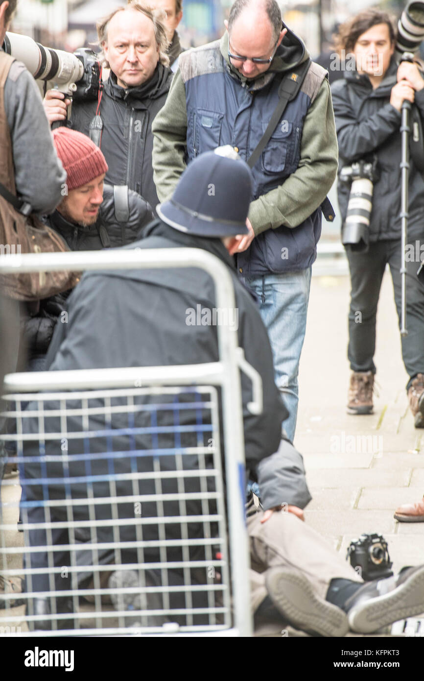 London, UK. 31st Oct, 2017. A press photographer, Alan Davidson, falls over and breaks his nose in the press scrumage outside 10 Downing Street Credit: Ian Davidson/Alamy Live News Stock Photo