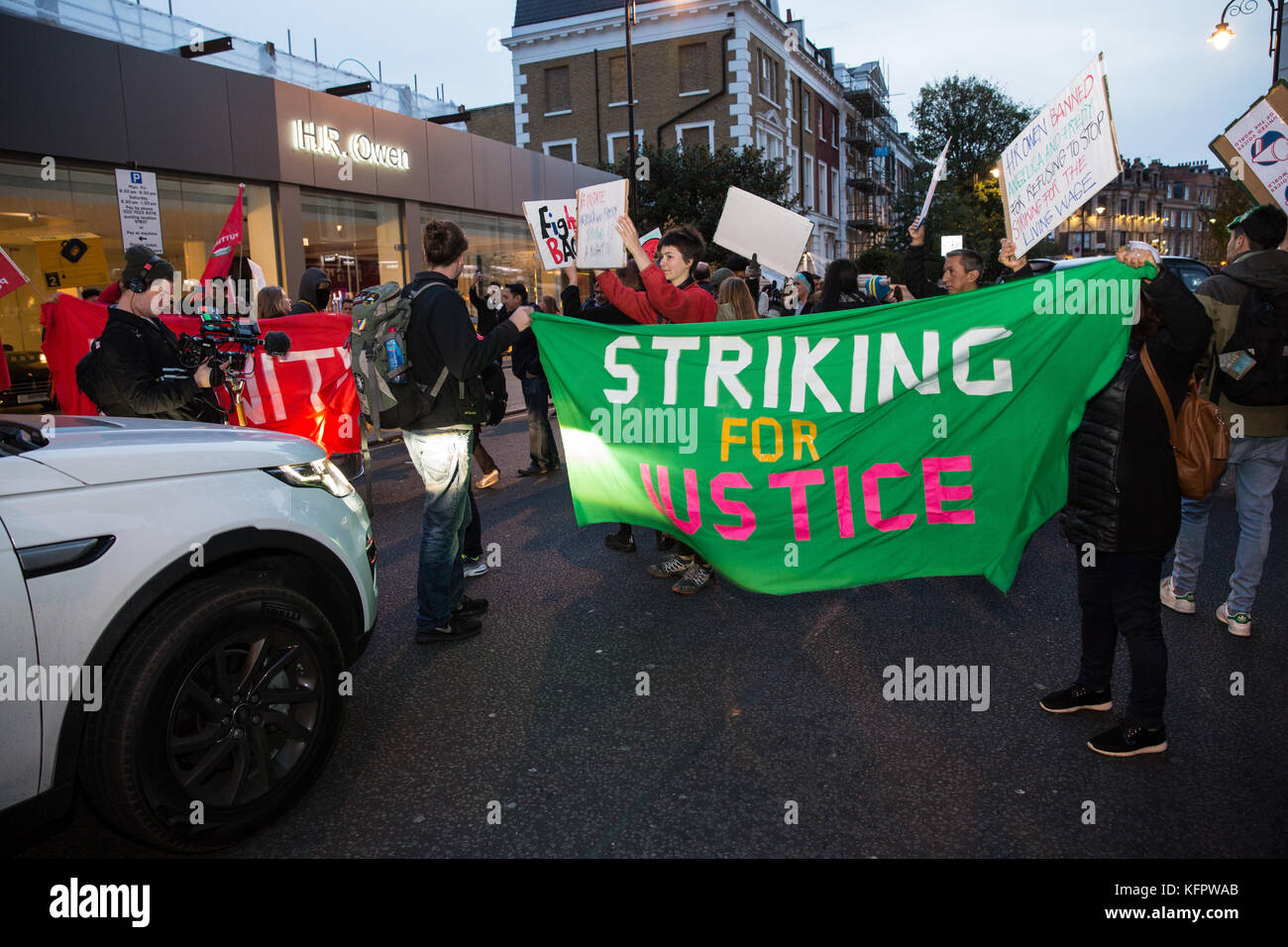 London, UK. 31st Oct, 2017. Supporters of migrant cleaners Angelica Valencia Bolanos and Fredy Lopez suspended without pay by contractor Templewood Cleaning for having joined trade union United Voices of the World and for having voted to strike for the London Living Wage protest outside luxury car dealer H.R. Owen's Ferrari showroom in South Kensington. The cleaners, a married couple, are the only cleaners responsible for cleaning H.R. Owen's Ferrari showroom via contractor Templewood Cleaning. Credit: Mark Kerrison/Alamy Live News Stock Photo