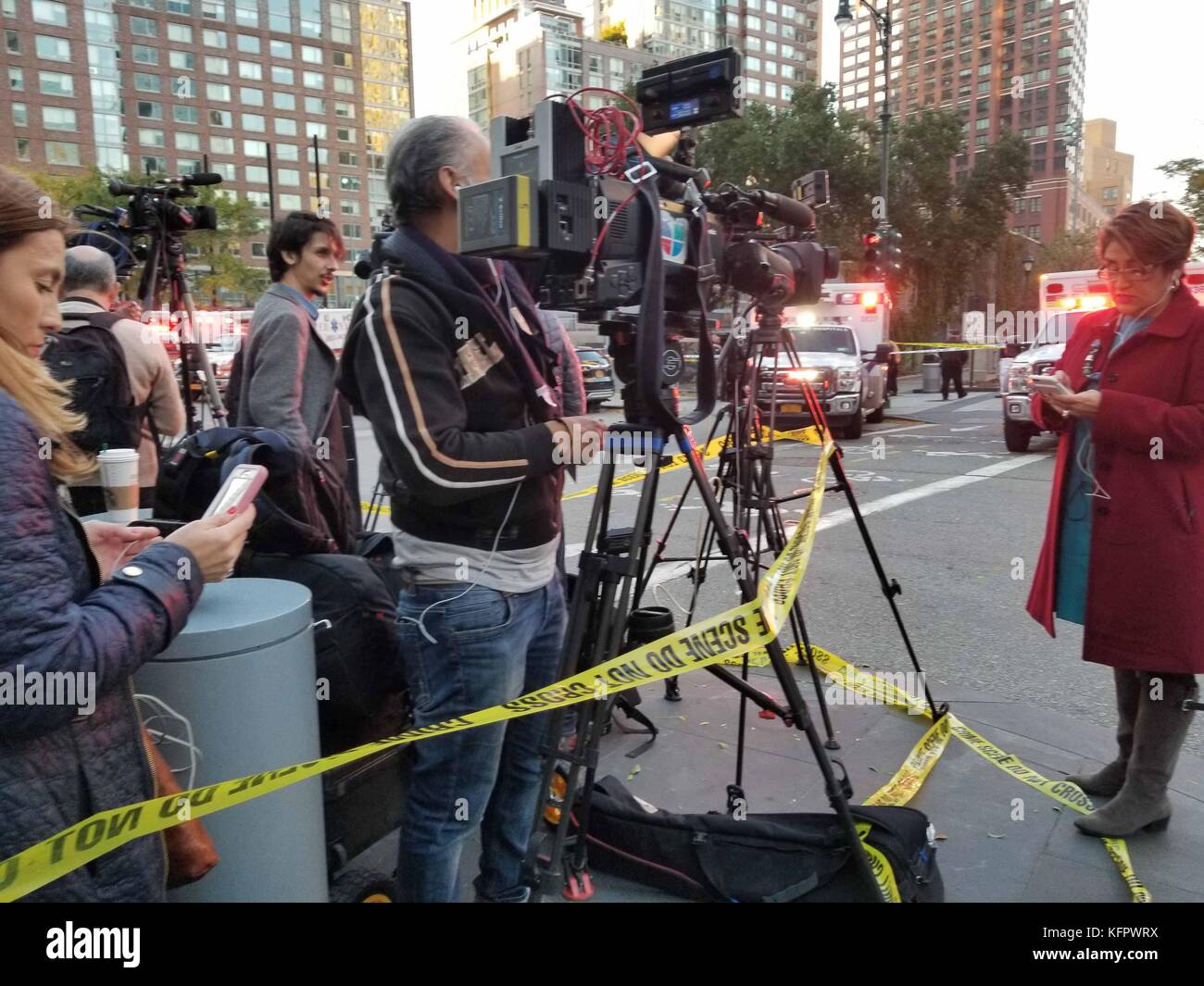 New York City, USA. 31st Oct, 2017. A news reporter gets ready to broadcast live at the scene of a terrorist attack near the World Trade Center in NYC. A driver kills several people in a rental truck in New York City, October 31, 2017. It has been reported suspect was caught alive by police after driving a rental truck on a popular bike path along the Hudson River in the Tribeca neighborhood. Credit: Brigette Supernova/Alamy Live News Stock Photo