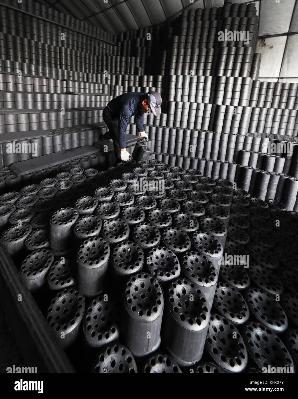 01st Nov, 2017. Shipping coal briquettes A worker loads coal briquettes