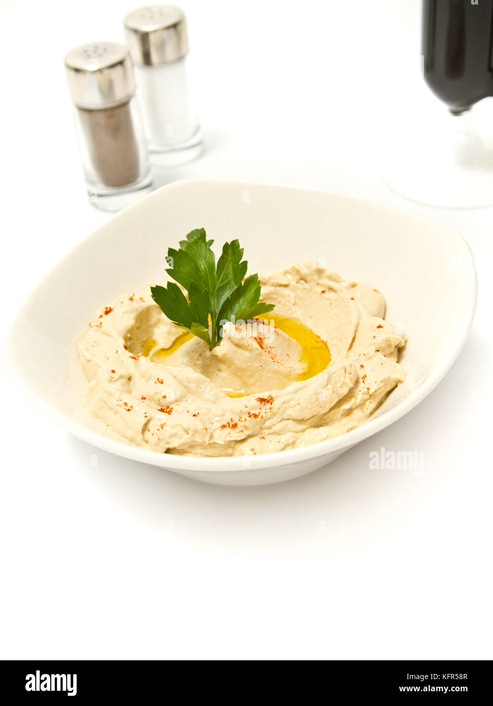 Bowl of hummus with parsely and olive oil Stock Photo