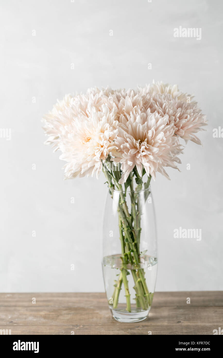 Vase with white chrysanthemum on a table of wooden planks Stock Photo -  Alamy