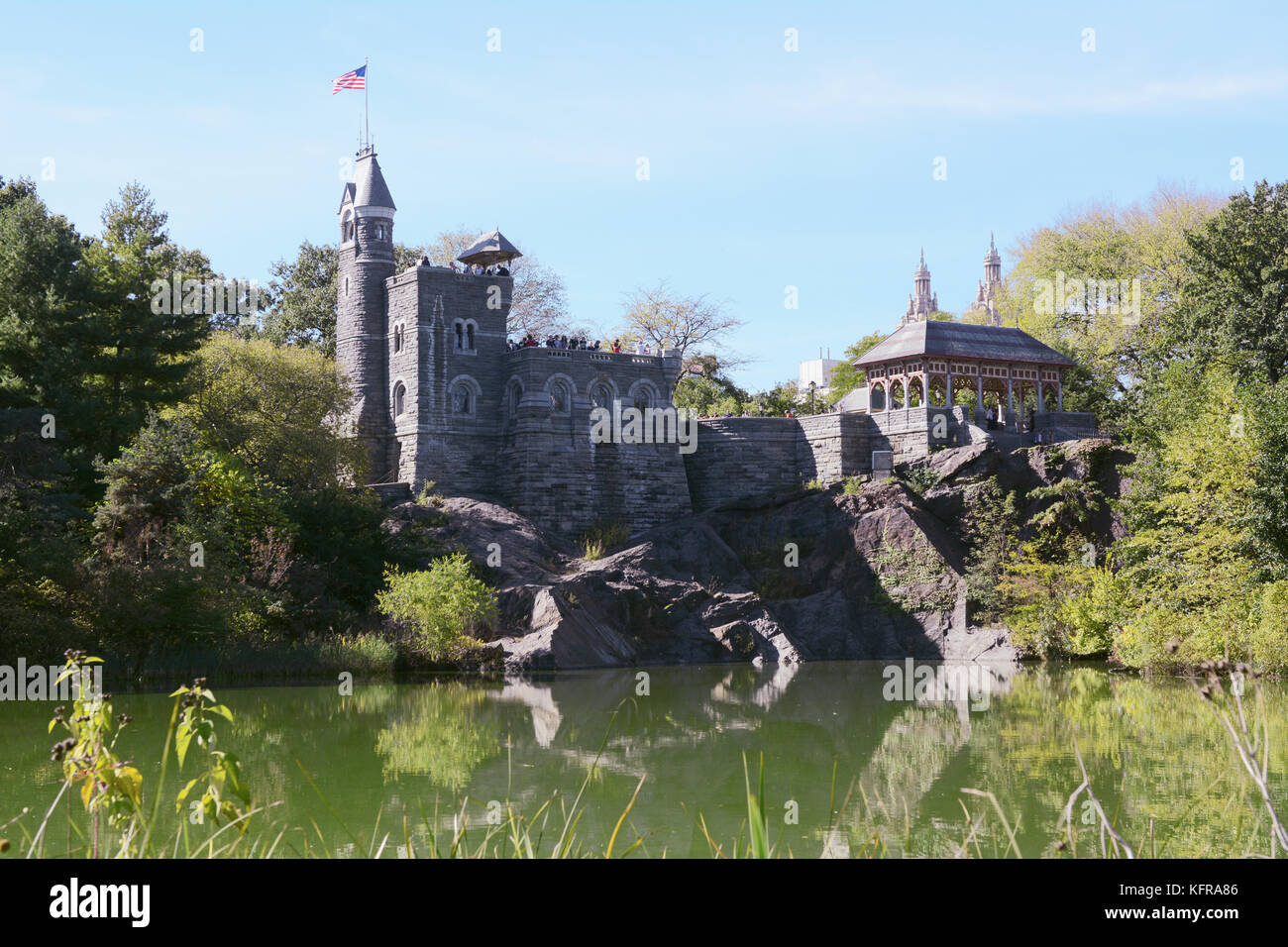 NEW YORK - OCTOBER 20, 2017: Belvedere Castle in Central Park, overlooking Turtle Pond. The American flag flies from the tower. Tourists take in the v Stock Photo