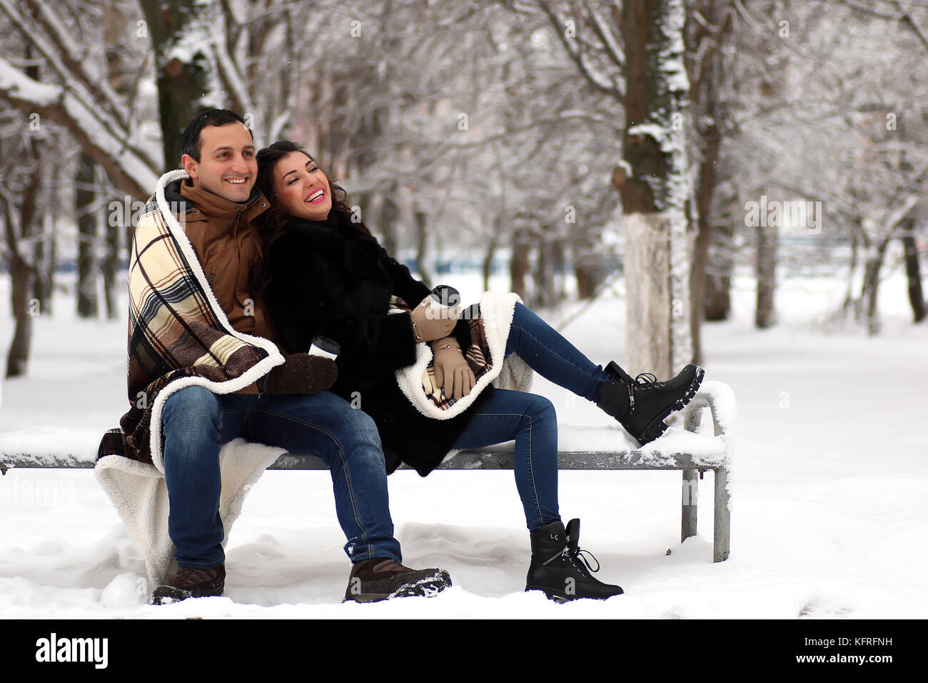 A young couple walk in a winter park Stock Photo - Alamy