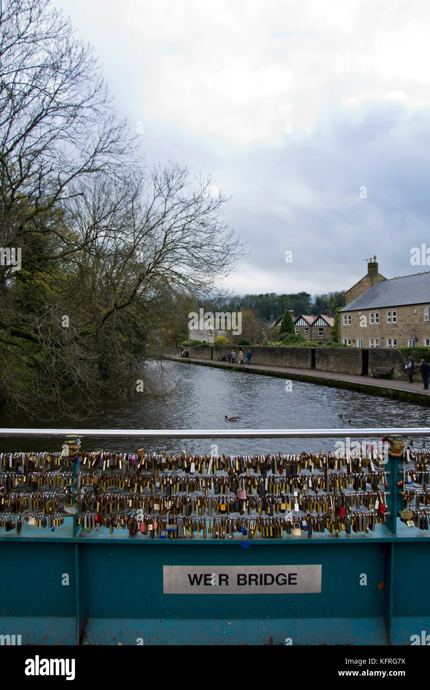 Love locks attached to Weir bridge, over the river Wye, Bakewell